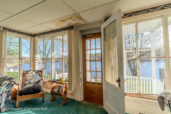 a living room with furniture and a floor to ceiling window