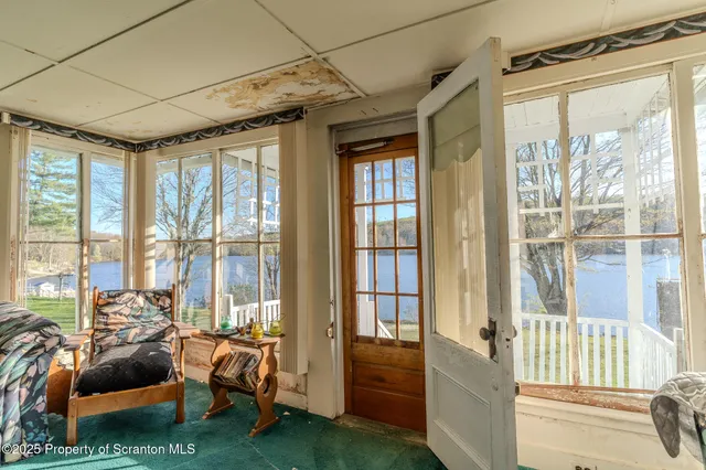 a living room with furniture and a floor to ceiling window