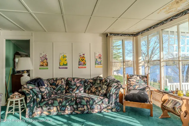 a living room with lots of furniture and a large window