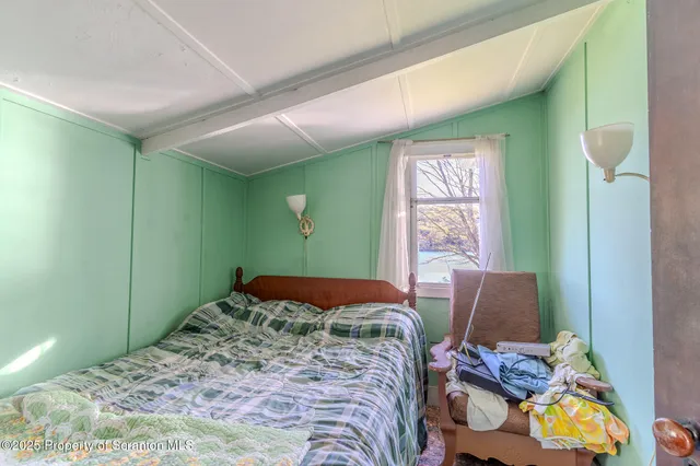 a bedroom with two beds and a window