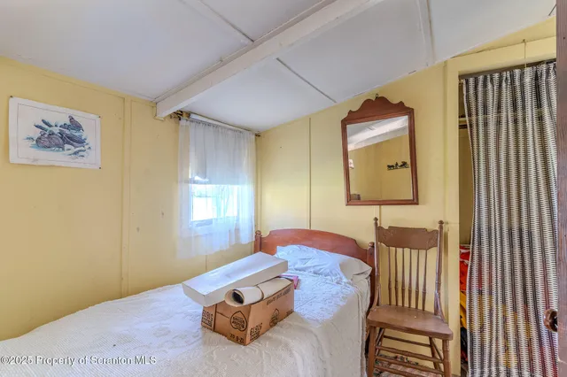 a bedroom with furniture and a window