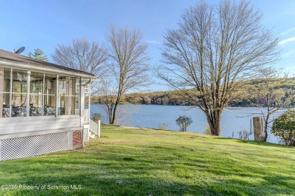 a view of house with backyard