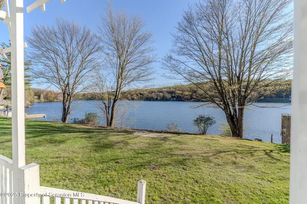a front view of a house with a yard garage and outdoor seating