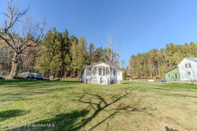 a view of a house with a backyard