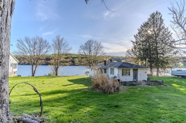 a house view with a sitting space and garden