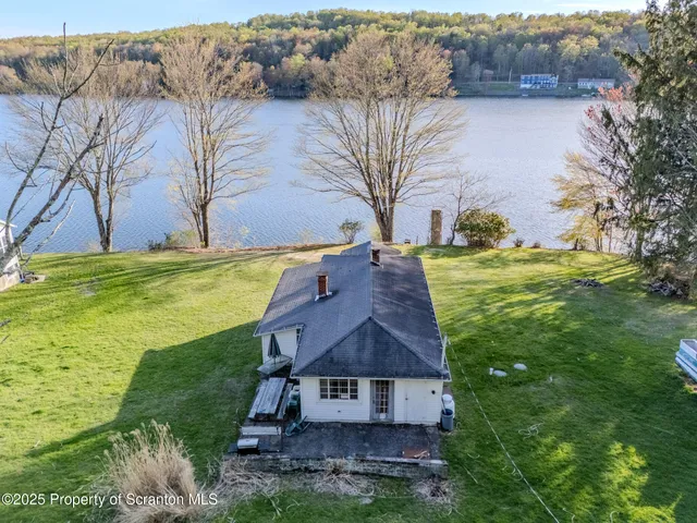an aerial view of a houses with ocean view
