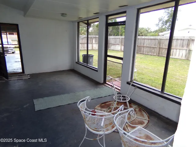 a dining room with furniture a chandelier and wooden floor