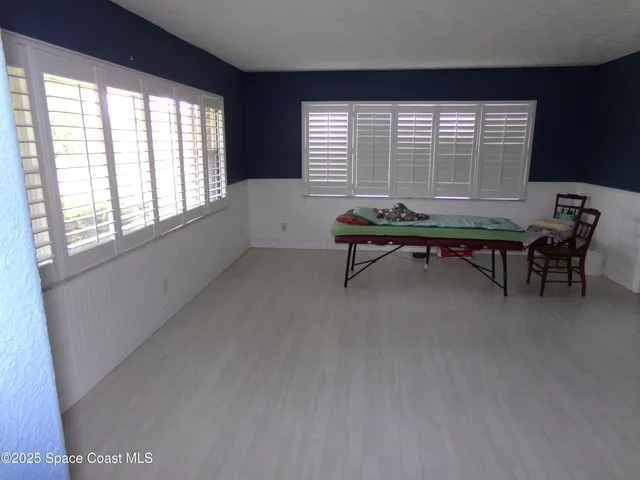 a sitting room with furniture and windows
