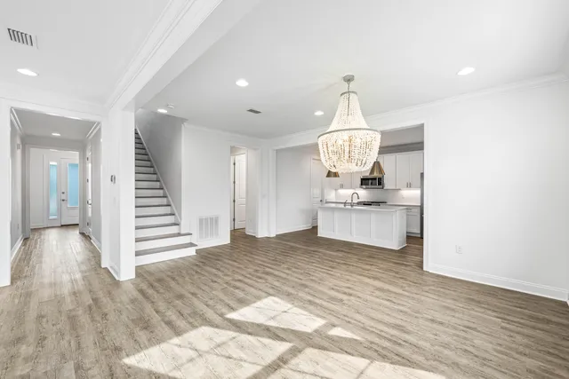 a view of kitchen with granite countertop stove top oven and cabinets