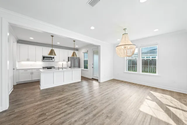 a view of livingroom with wooden floor and windows