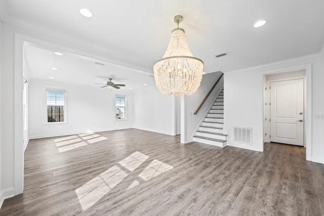 a kitchen with stainless steel appliances granite countertop a sink a stove a refrigerator and island with wooden floor