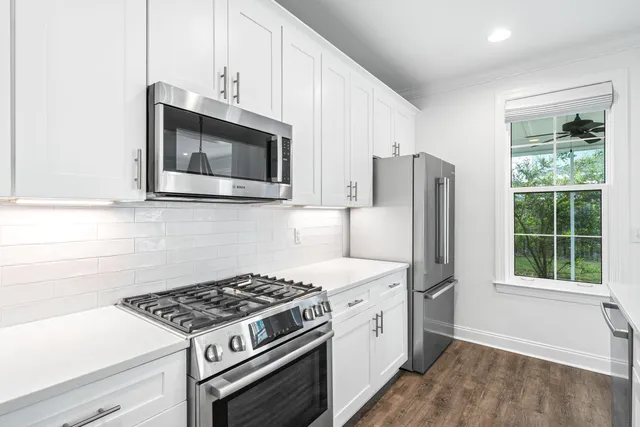 a view of center island a wooden floor and a large window