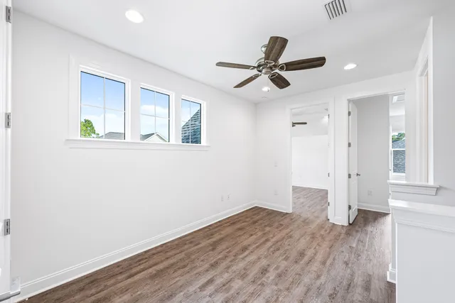 a view of empty room with wooden floor