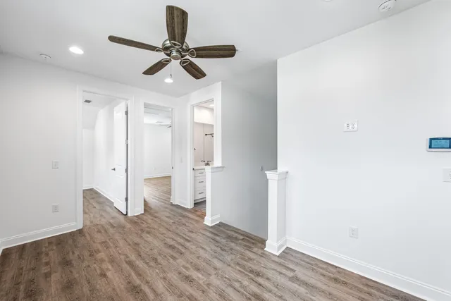wooden floor in an empty room with a bathroom