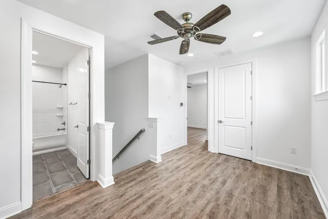 a bathroom with a granite countertop sink a toilet and shower