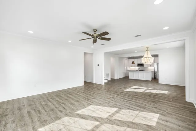 a view of a kitchen with a sink and a refrigerator