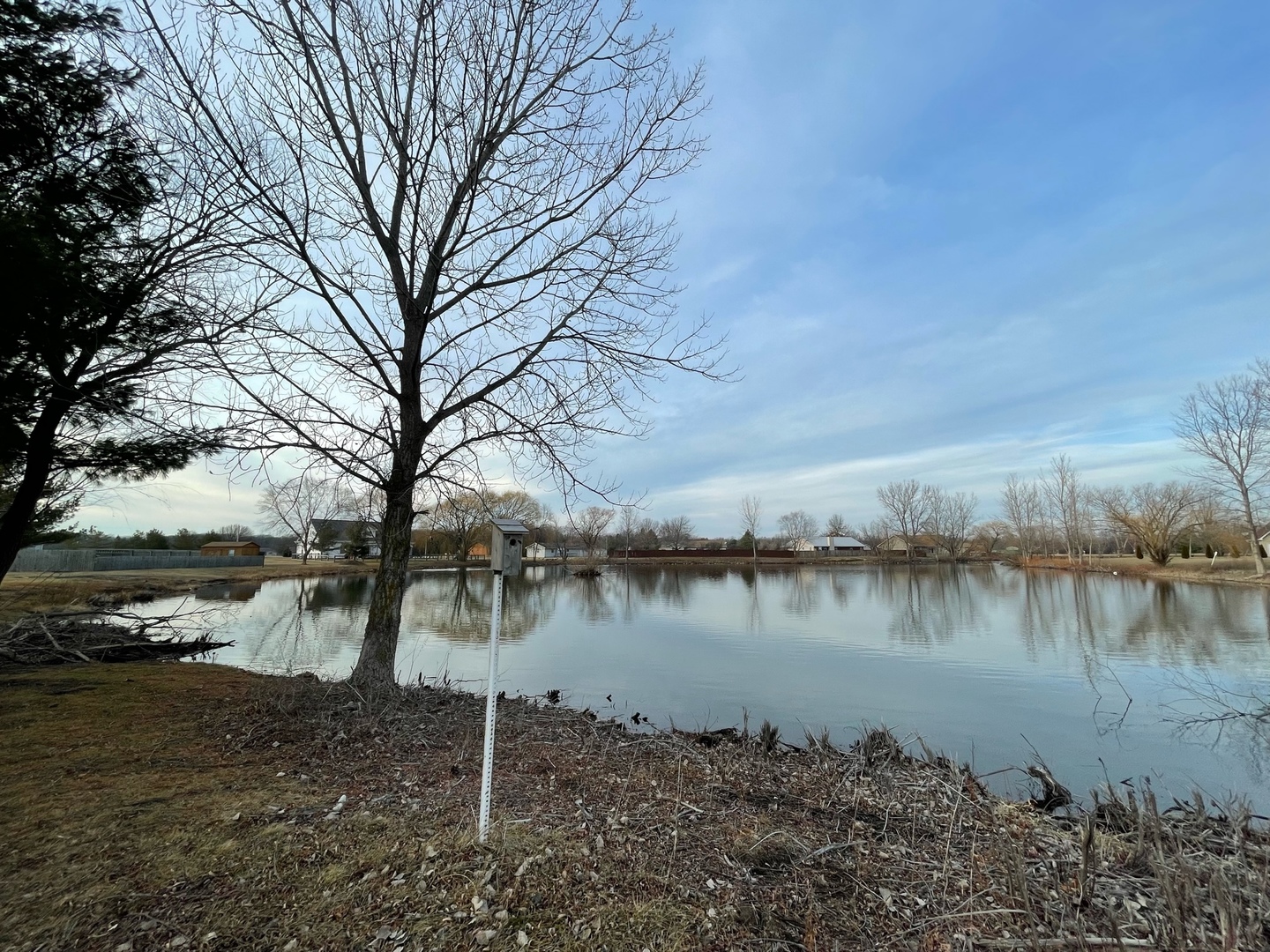 a lake view with a wooden fence