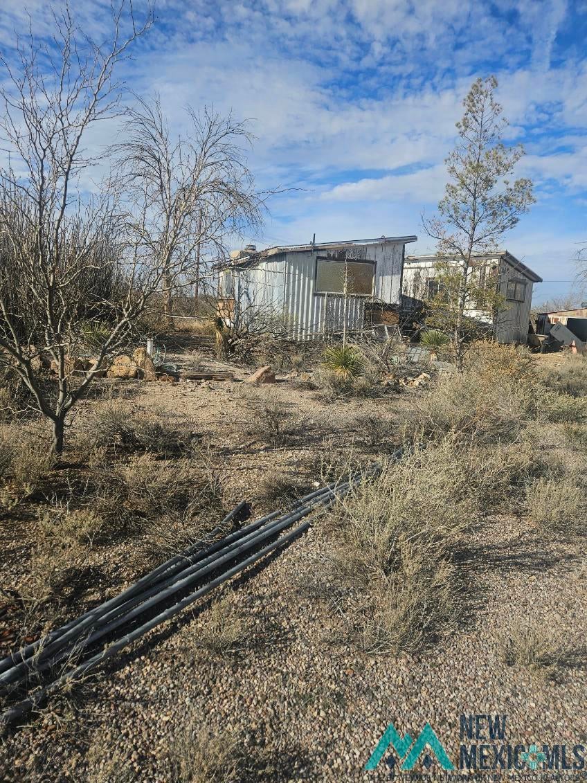 49 Cattle Rest Road Lordsburg, NM 88045 - Photo 2 of 6 View of yard with an outdoor structure