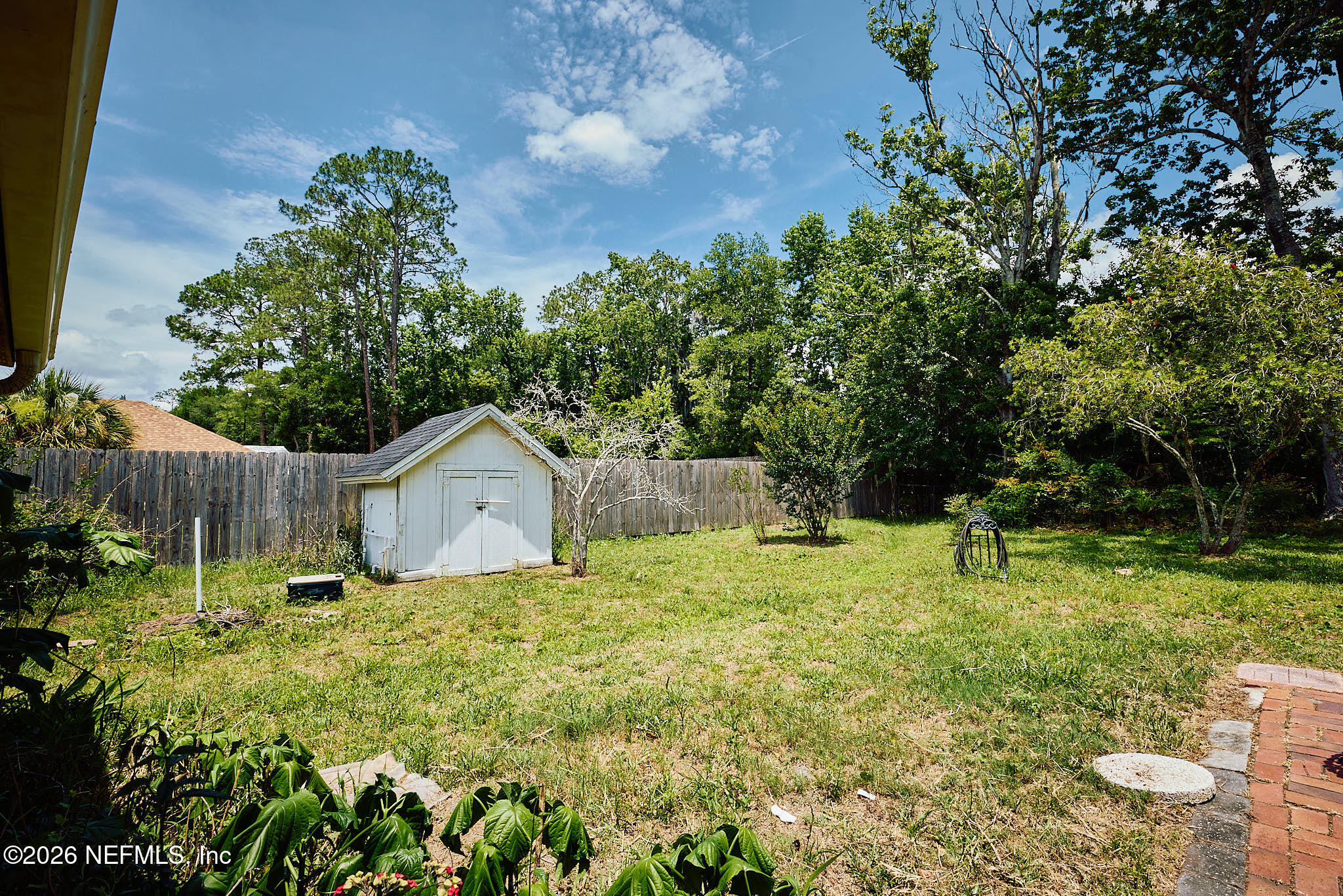 8965 San Rae Road Jacksonville, FL 32257 - Photo 31 of 46 a backyard of a house with table and chairs