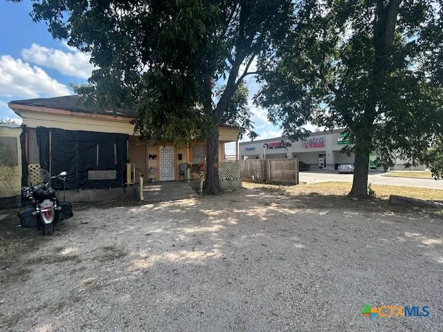 a view of a house with a yard and garage
