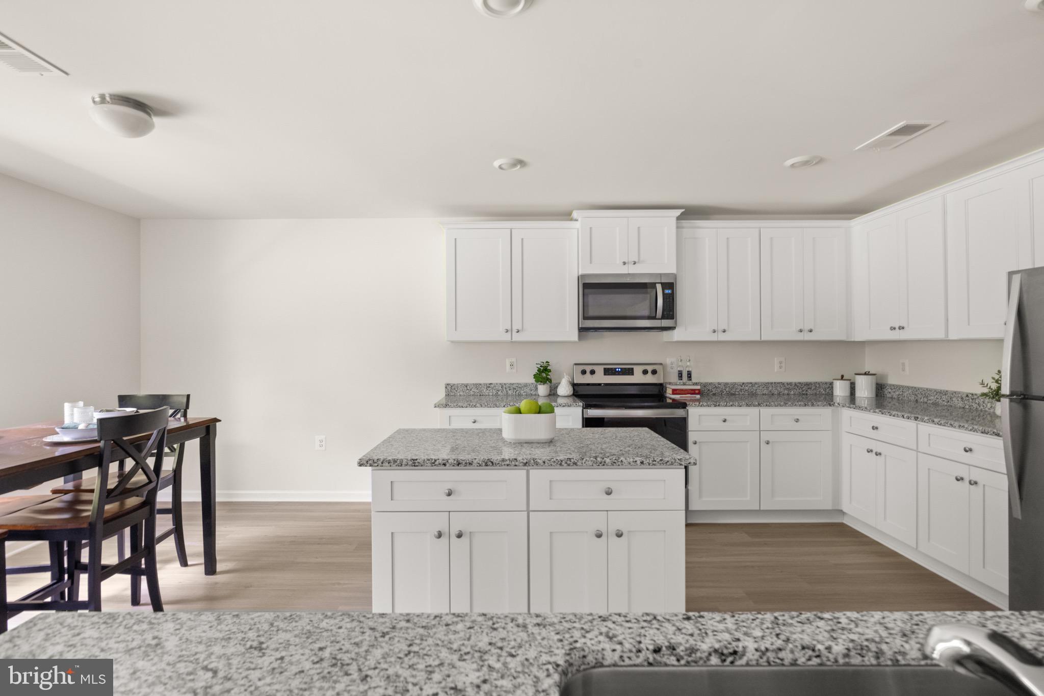 259 Headwaters Drive Falling Waters, WV 25419 - Photo 12 of 34 a kitchen with granite countertop white cabinets and stainless steel appliances