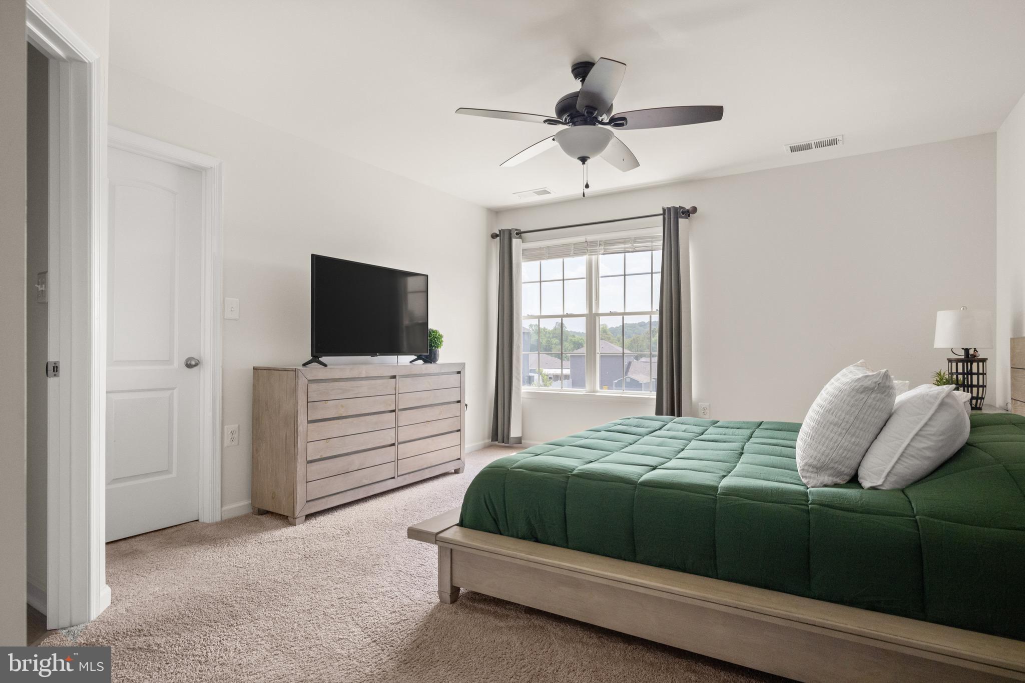 259 Headwaters Drive Falling Waters, WV 25419 - Photo 16 of 34 a bedroom with a bed and a flat screen tv