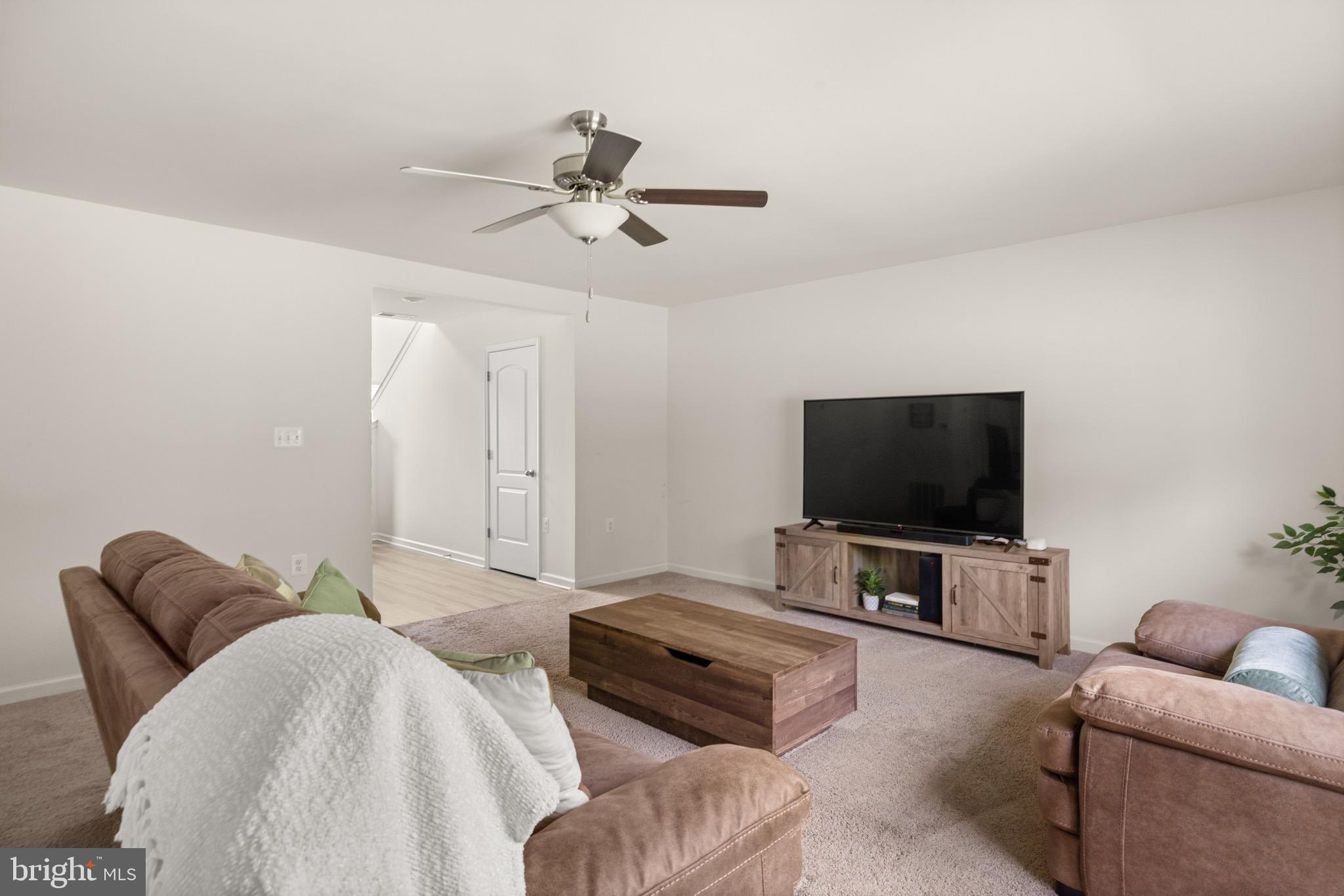 259 Headwaters Drive Falling Waters, WV 25419 - Photo 4 of 34 a living room with furniture and a flat screen tv