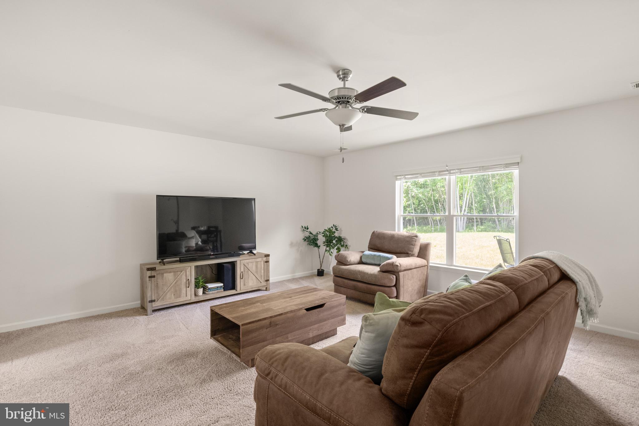 259 Headwaters Drive Falling Waters, WV 25419 - Photo 5 of 34 a living room with furniture and a flat screen tv