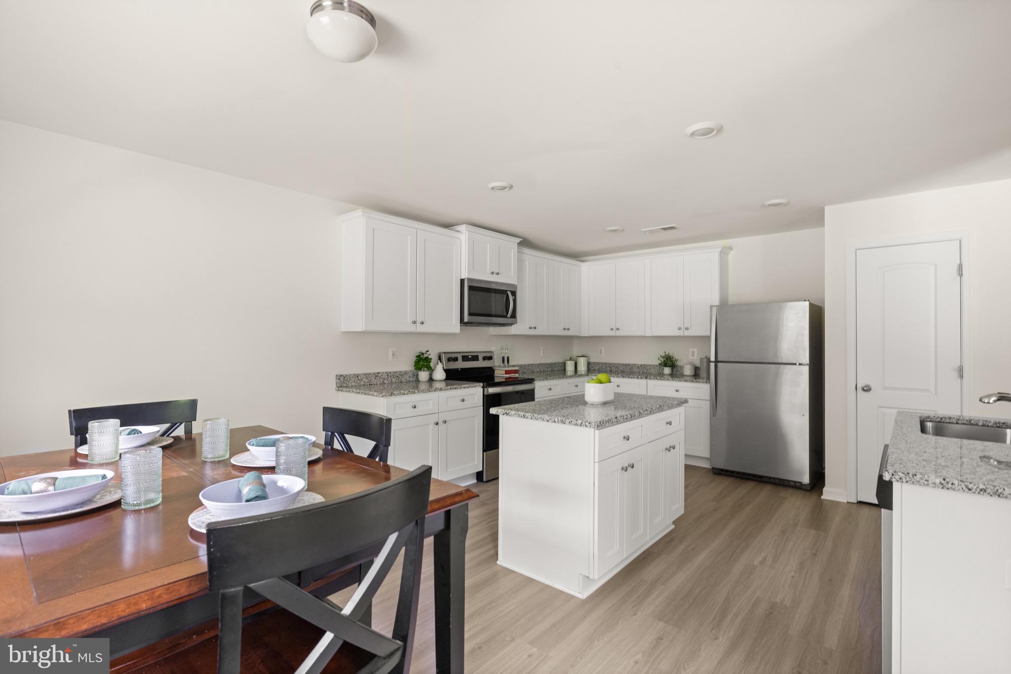 259 Headwaters Drive Falling Waters, WV 25419 - Photo 8 of 34 a kitchen with a sink white cabinets and stainless steel appliances
