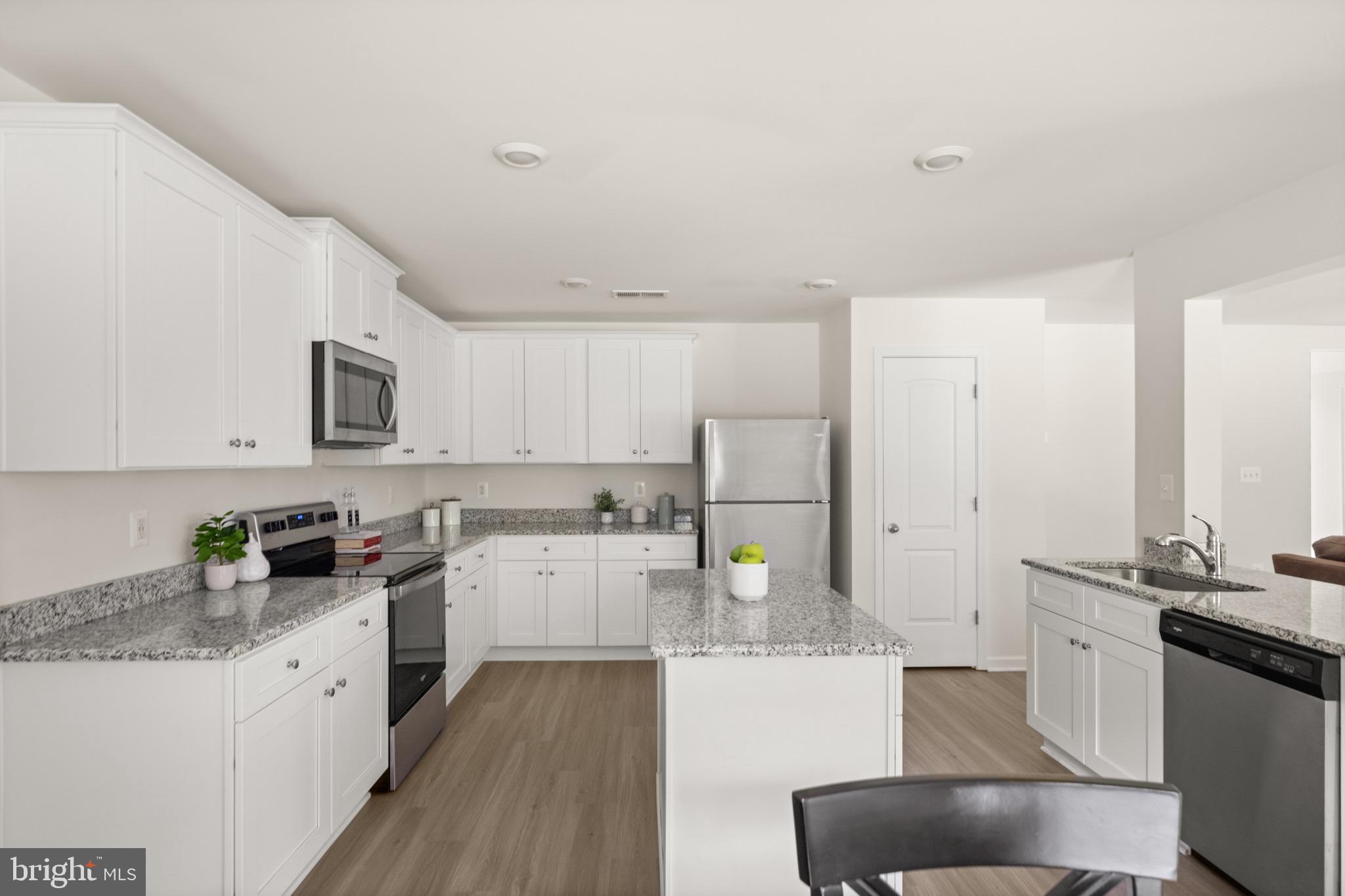 259 Headwaters Drive Falling Waters, WV 25419 - Photo 9 of 34 a kitchen with stainless steel appliances a stove a sink a microwave a refrigerator a cabinets and wooden floor