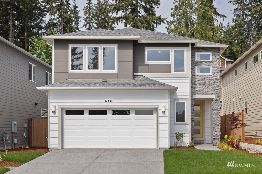 609 215th Street Southeast, Unit RM23 Bothell, WA 98021 - Photo 1 of 23 a front view of a house with a garden