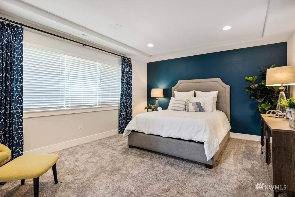 609 215th Street Southeast, Unit RM23 Bothell, WA 98021 - Photo 12 of 23 a bedroom with a bed a chair and a large window
