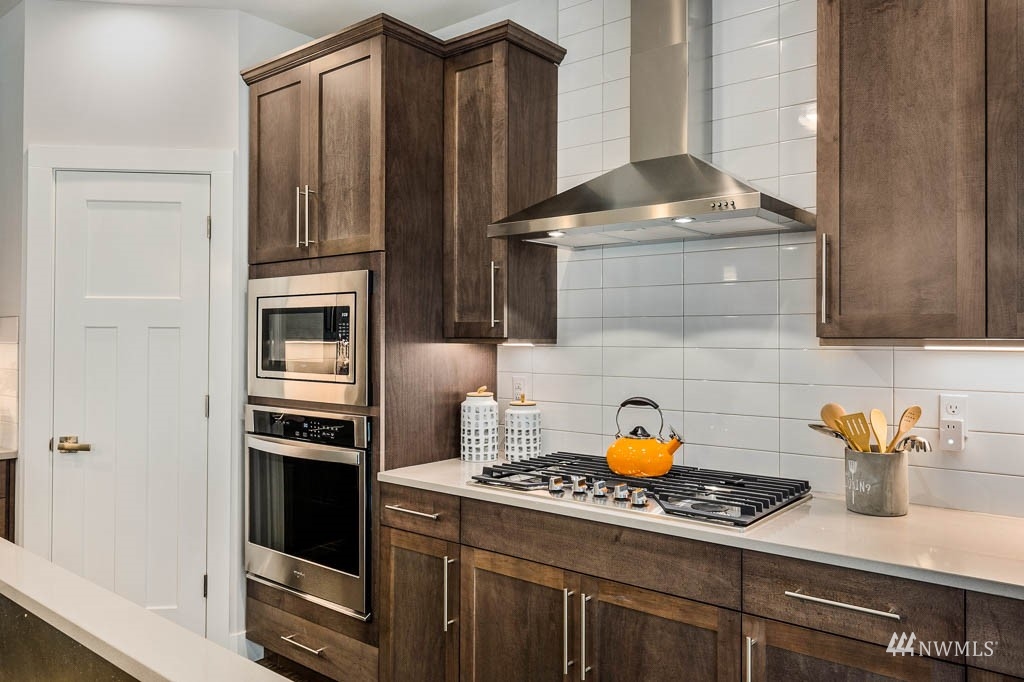 609 215th Street Southeast, Unit RM23 Bothell, WA 98021 - Photo 6 of 23 a kitchen with stainless steel appliances a stove and a refrigerator