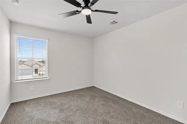 a view of a backyard with wooden fence