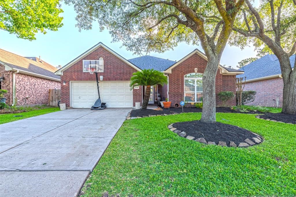 20235 Concord Hill Drive Cypress, TX 77433 - Photo 2 of 27 a house with green field in front of it