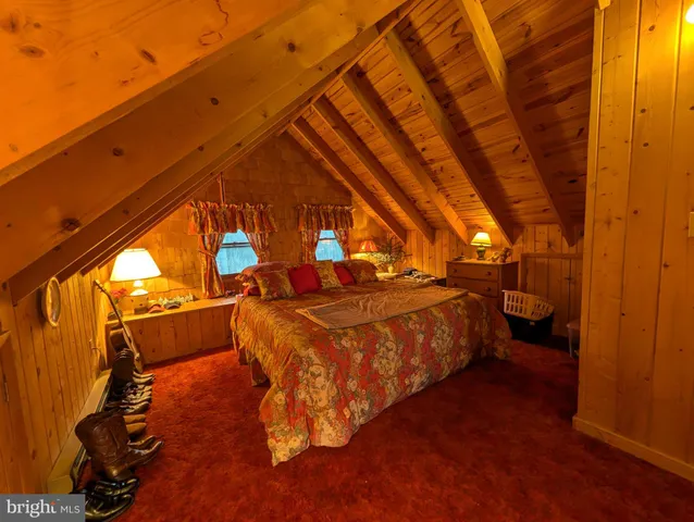 a bed sitting in a room next to a window