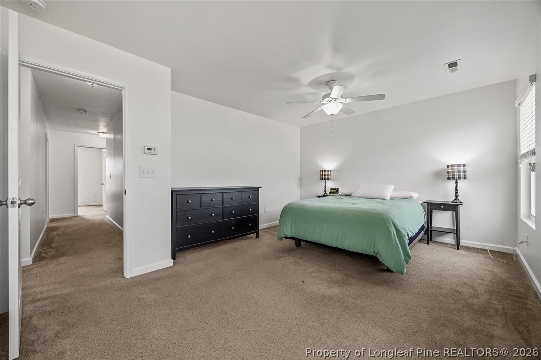 226 River Oak Street Spring Lake, NC 28390 - Photo 25 of 41 a bedroom with a bed and a chandelier