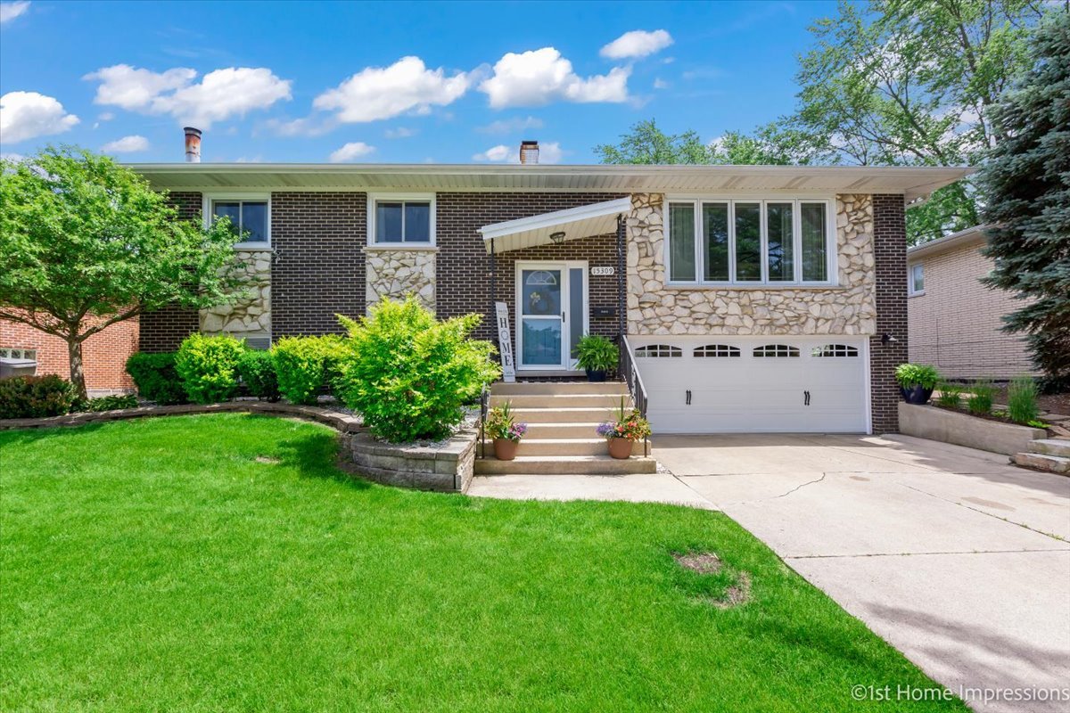 15309 Walnut Road Oak Forest, IL 60452 - Photo 1 of 26 a front view of a house with a garden and yard