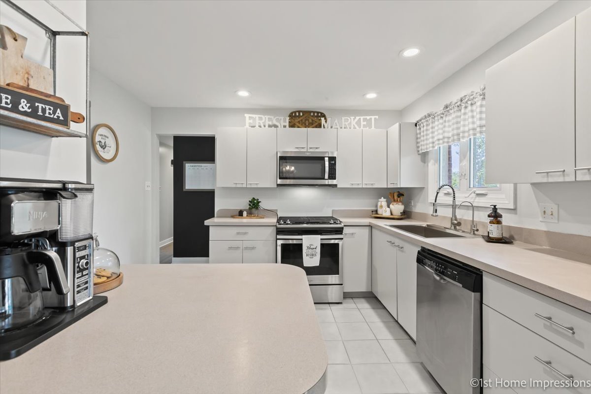 15309 Walnut Road Oak Forest, IL 60452 - Photo 15 of 26 a kitchen with stainless steel appliances granite countertop a sink stove and refrigerator