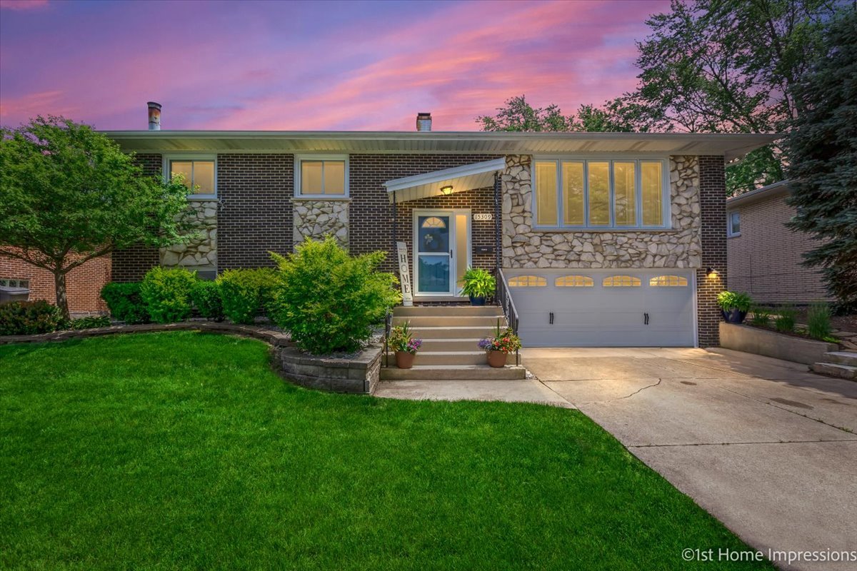 15309 Walnut Road Oak Forest, IL 60452 - Photo 2 of 26 a front view of a house with garden