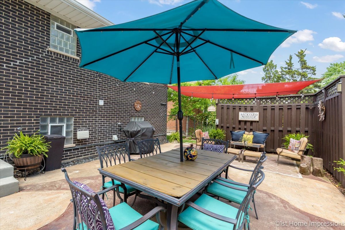 15309 Walnut Road Oak Forest, IL 60452 - Photo 22 of 26 a view of a patio with a table and chairs under an umbrella