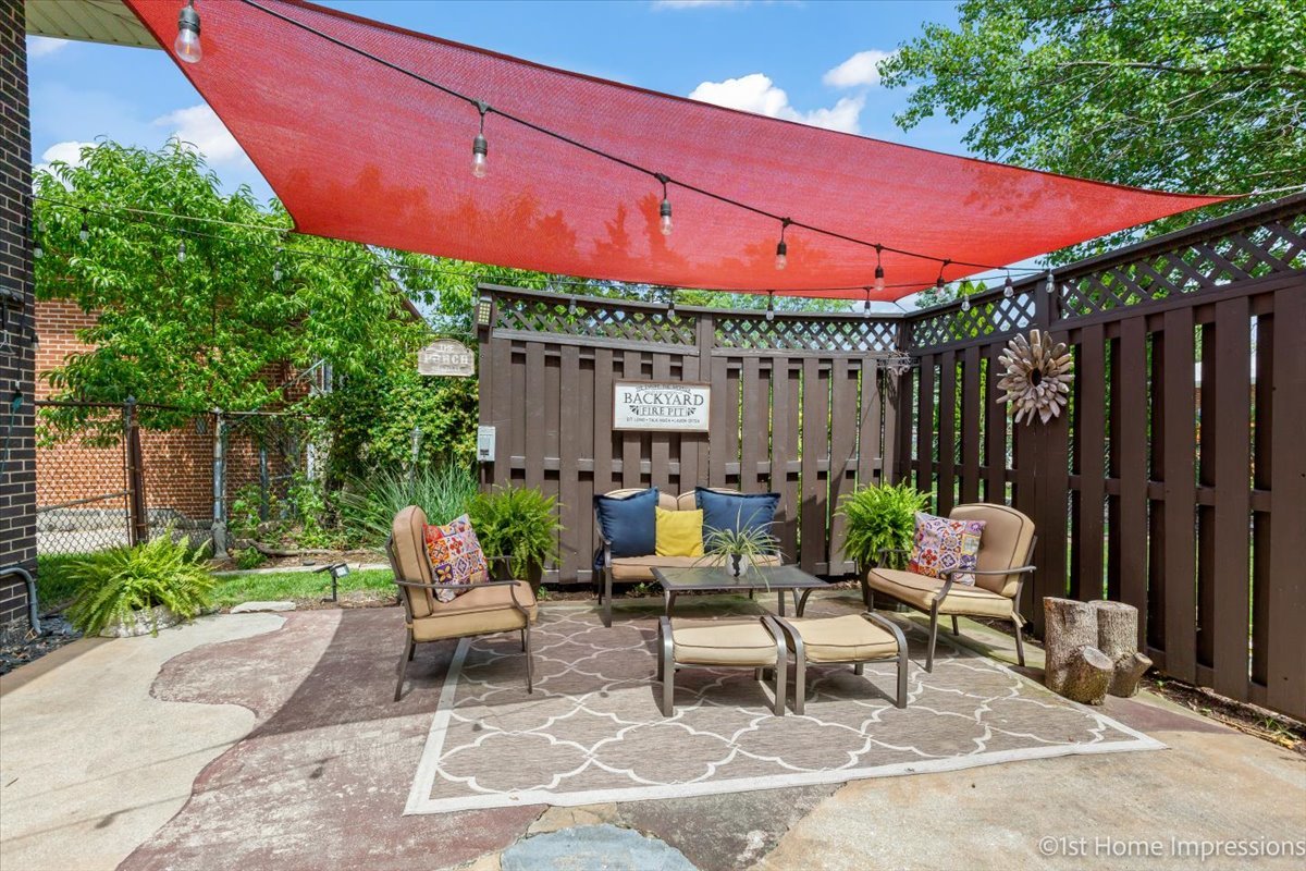 15309 Walnut Road Oak Forest, IL 60452 - Photo 24 of 26 a patio with a table and chairs under an umbrella