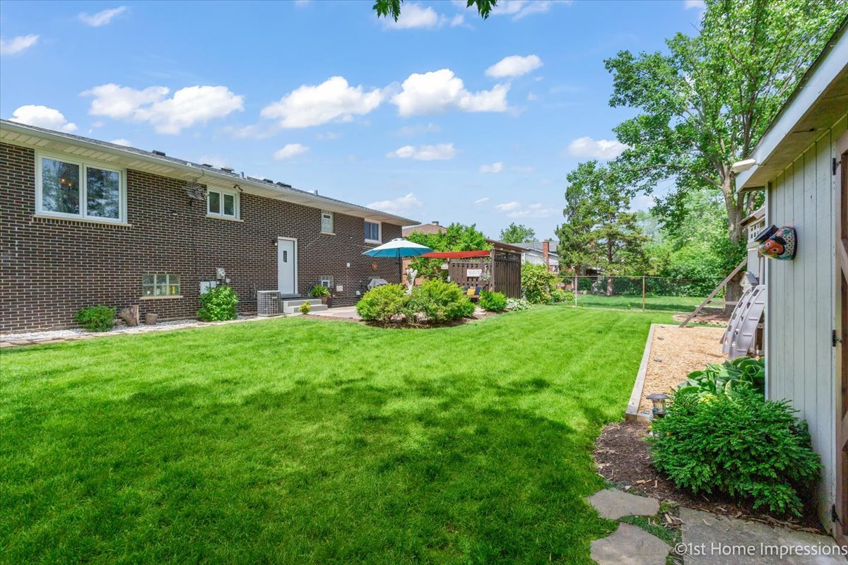 15309 Walnut Road Oak Forest, IL 60452 - Photo 26 of 26 a view of a backyard with potted plants and a large tree