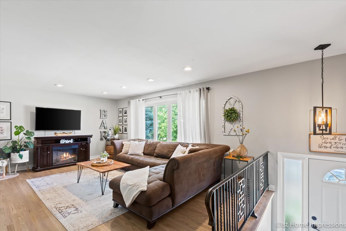 15309 Walnut Road Oak Forest, IL 60452 - Photo 3 of 26 a living room with furniture a flat screen tv and a large window
