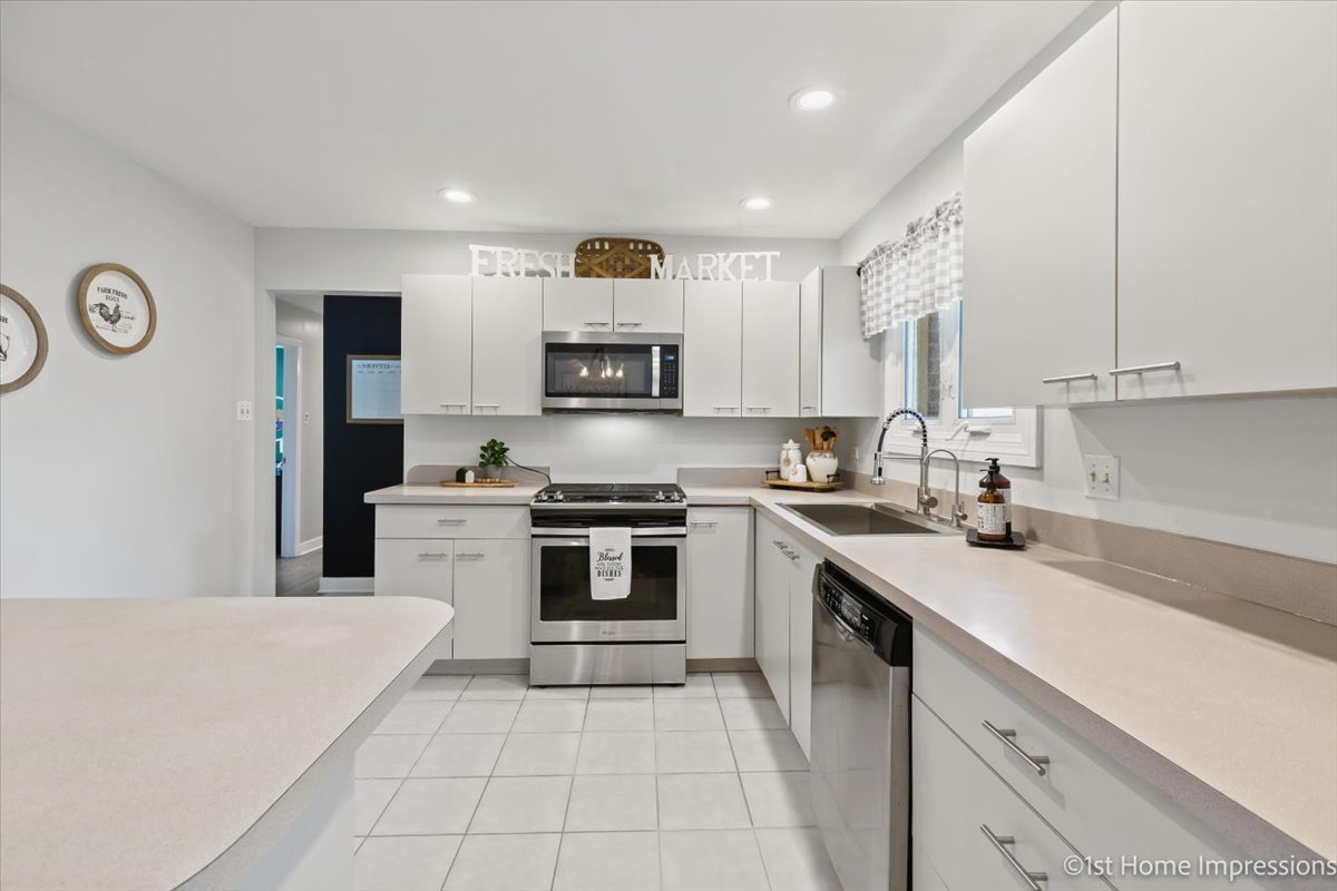 15309 Walnut Road Oak Forest, IL 60452 - Photo 7 of 26 a kitchen with a sink a stove top oven and white cabinets