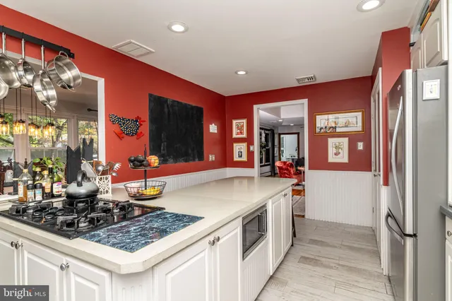 a kitchen with stainless steel appliances granite countertop a stove and a sink