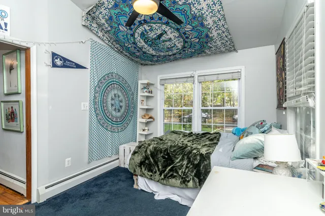 a bedroom with a large bed and a chandelier