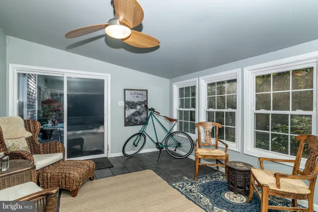 a view of house with backyard and sitting area