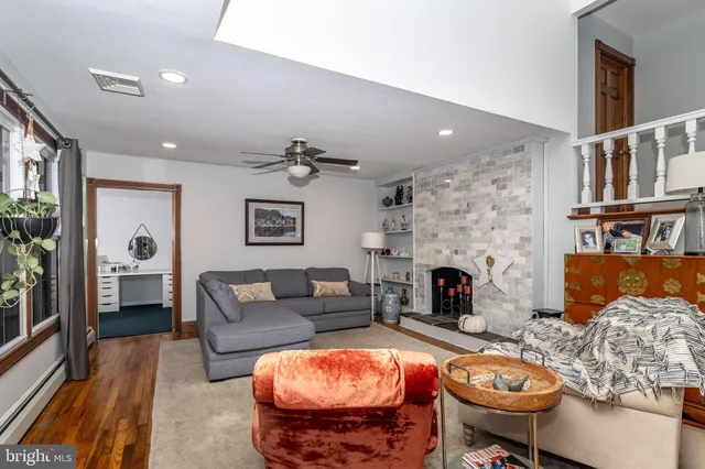 a living room with furniture and a fireplace