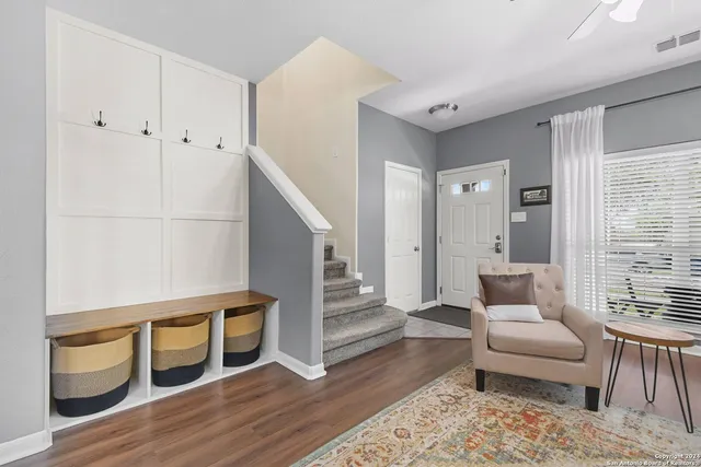 a living room with furniture and a wooden floor